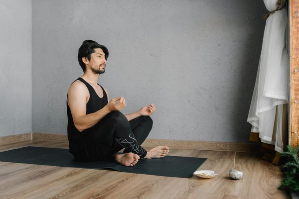 A person sitting calmly in a well-lit room, suggesting focus and mindfulness.